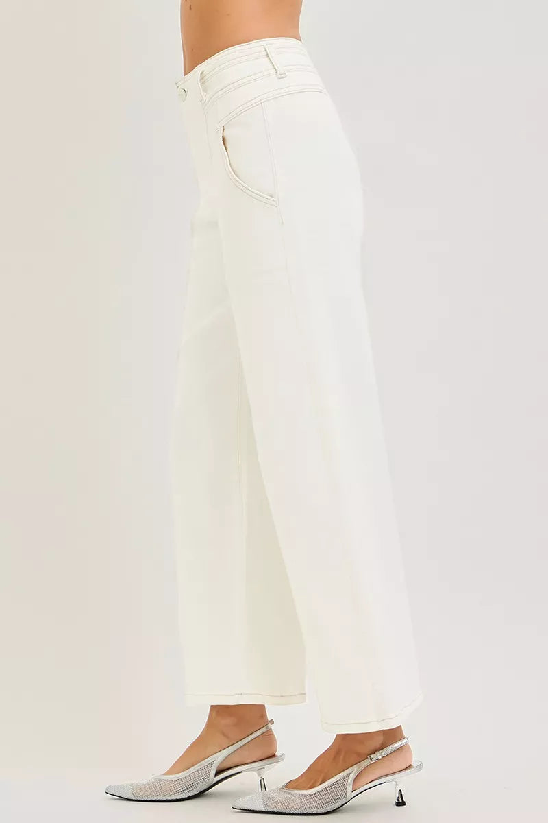 RISEN high-rise cream denim wide-leg pants, side view with wide hem and seams