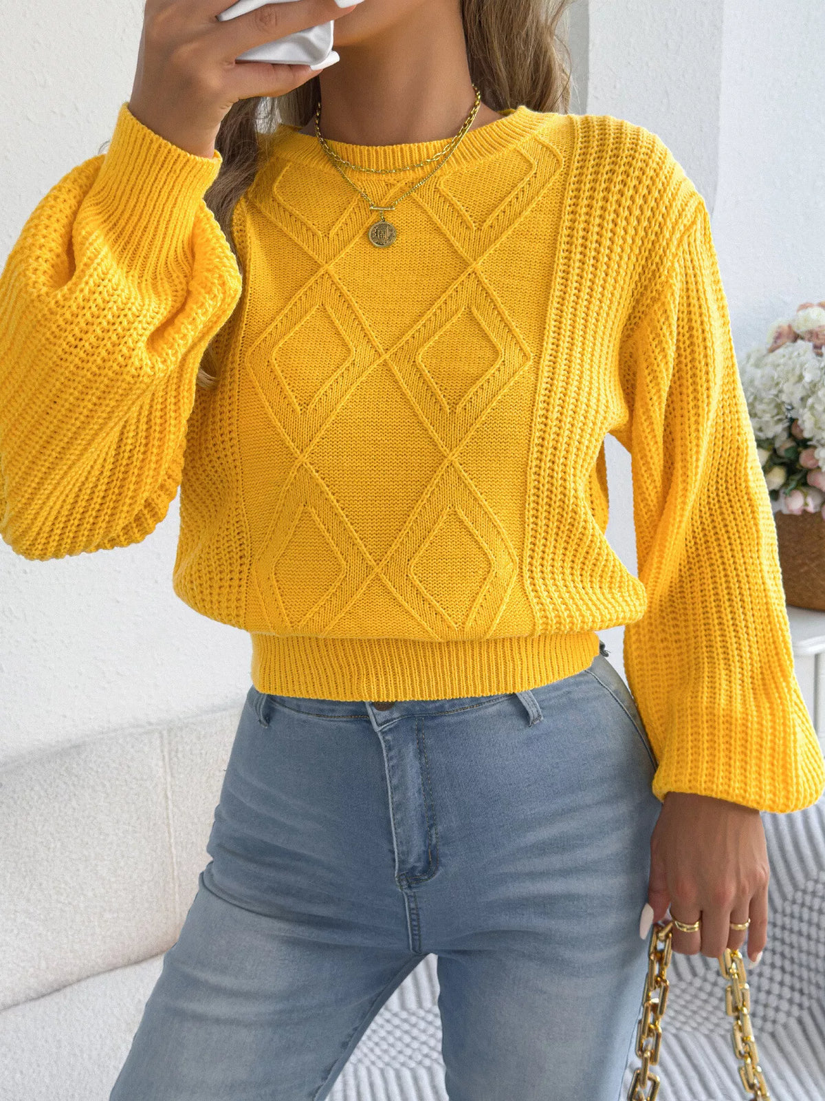 Yellow argyle knit sweater with lantern sleeves, crew neckline, and ribbed trim