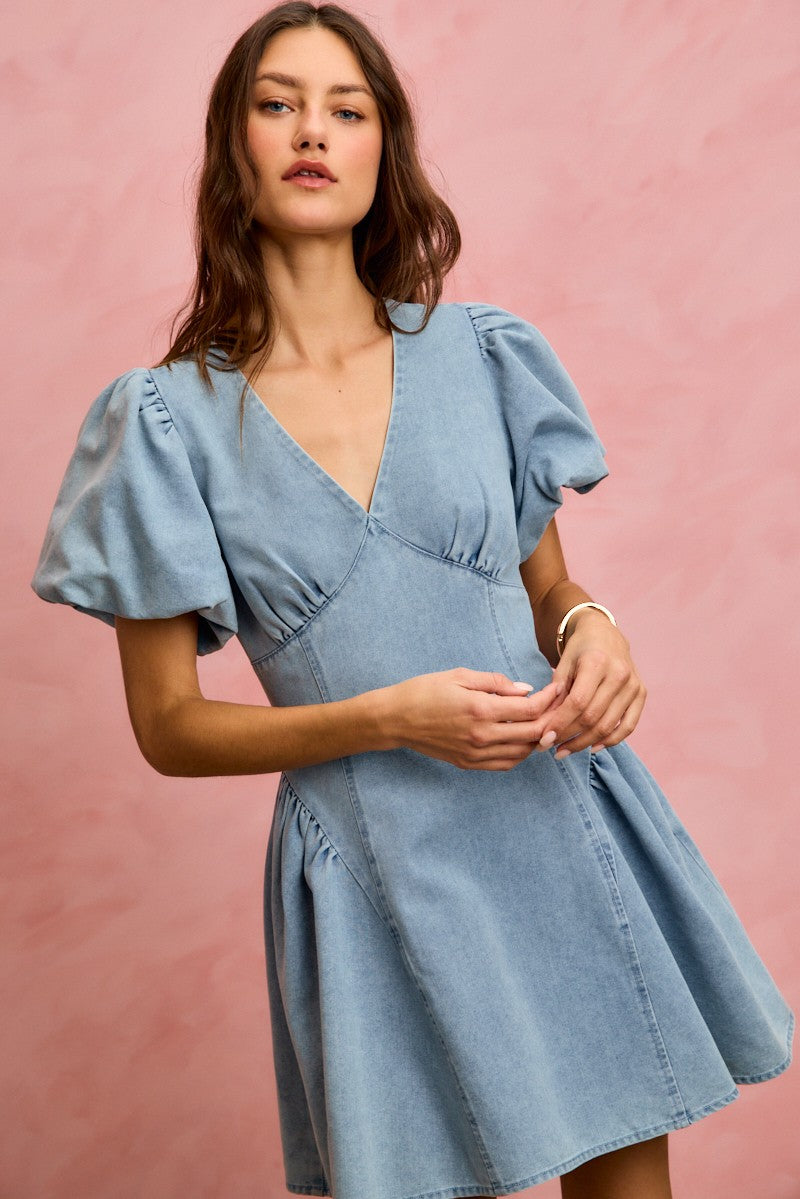 Light wash denim mini dress with V-neck and puff bubble sleeves, fitted through waist