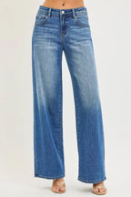 Women's medium-wash denim jeans with slouchy baggy legs, front pockets, button closure