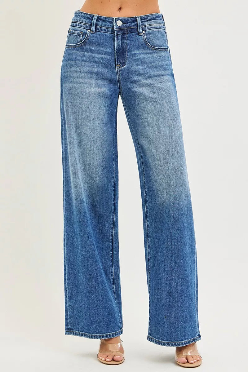 Women's medium-wash denim jeans with slouchy baggy legs, front pockets, button closure