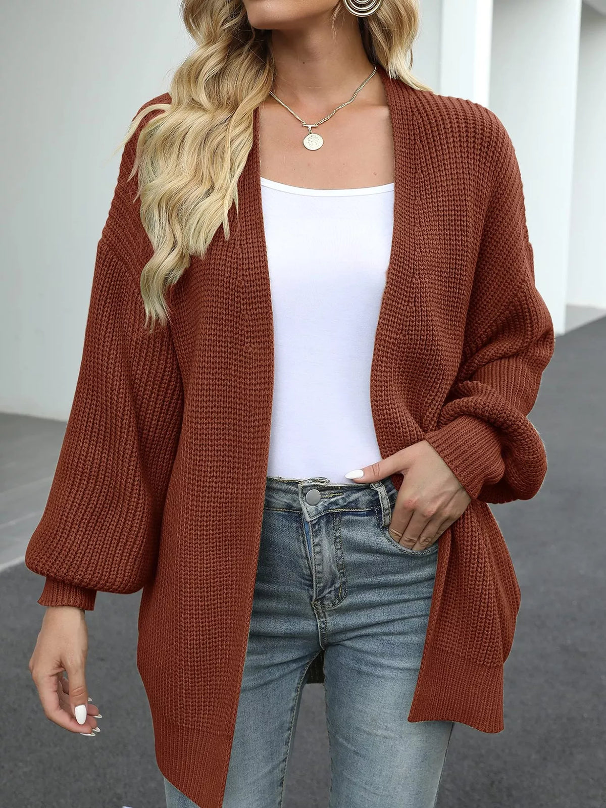 Chunky knit lantern sleeve cardigan in rust brown, open front, long lantern sleeves.