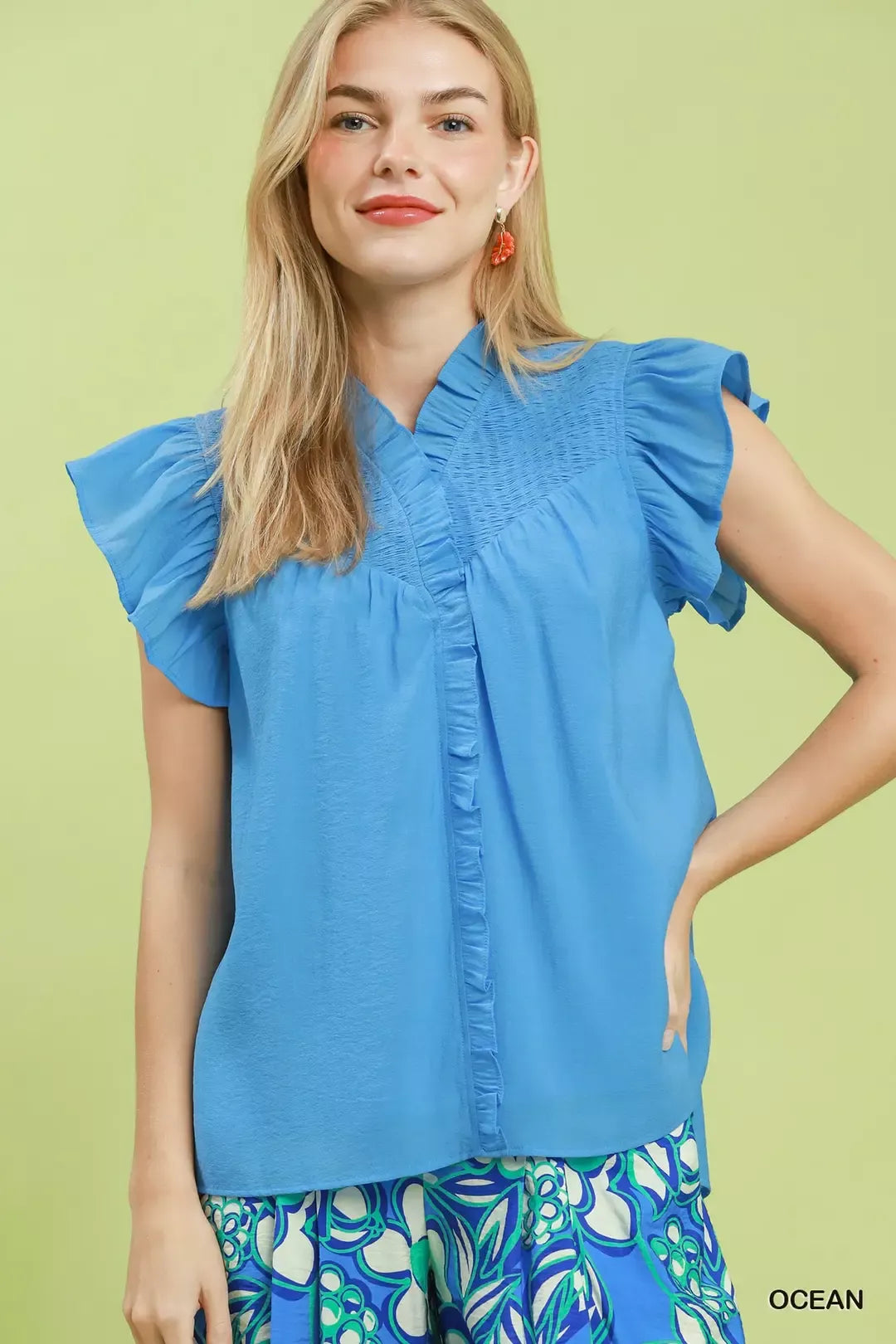 Ocean blue smocked yoke ruffle cap sleeve blouse with V-neck and button placket