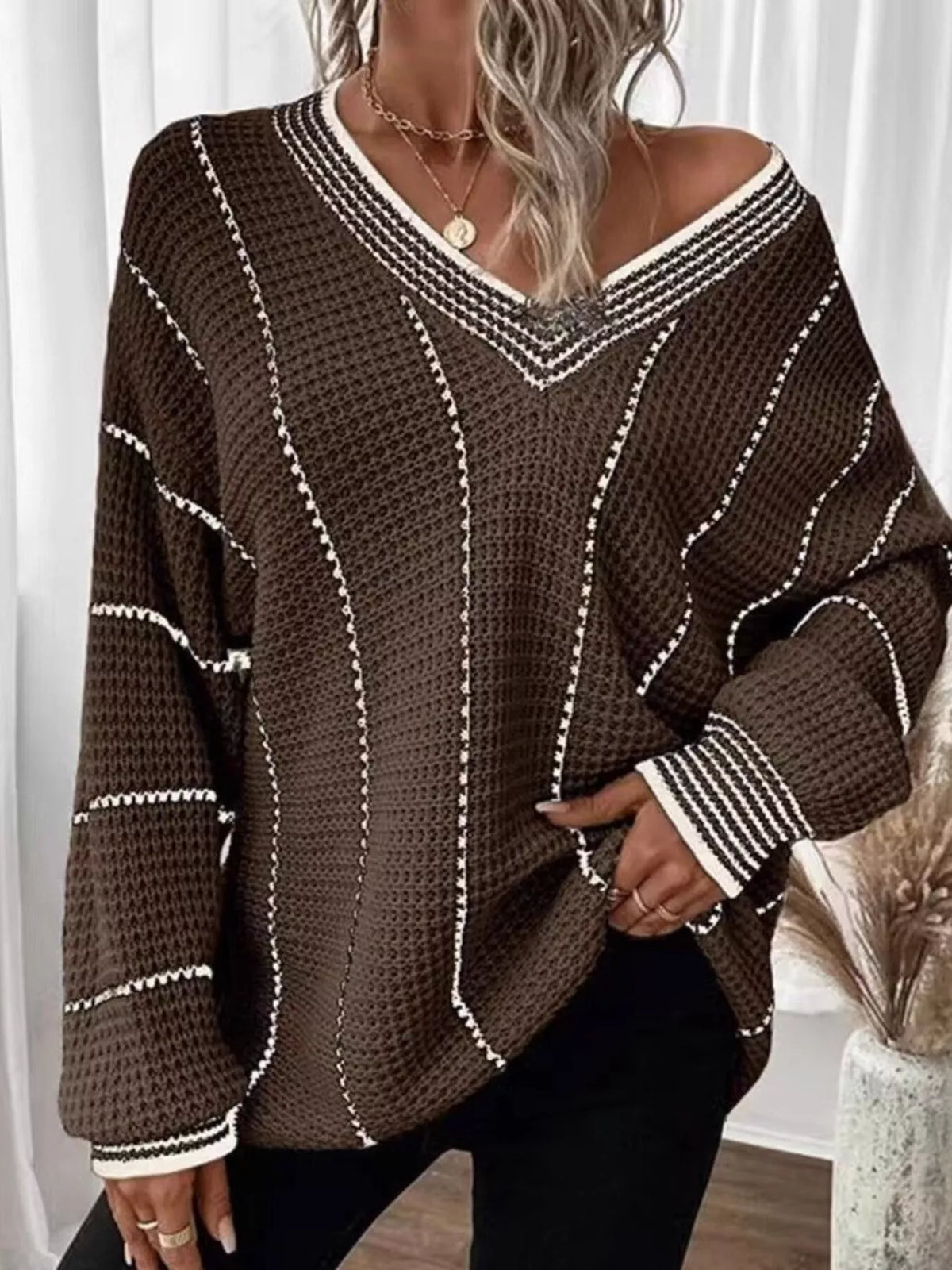 Brown V-neck textured knit sweater with white vertical stripe trim and ribbed cuffs