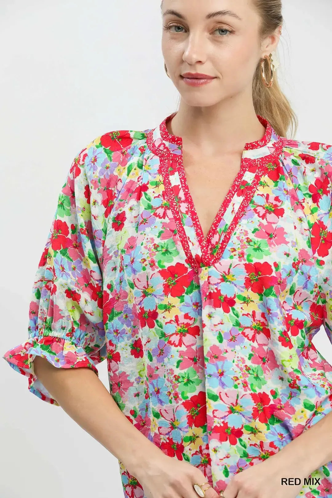 Red-and-blue mixed floral ruffle top with V-neck trim and bell-shaped sleeves