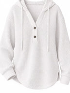 White waffle-knit button hoodie with hood and front button placket; textured fabric.
