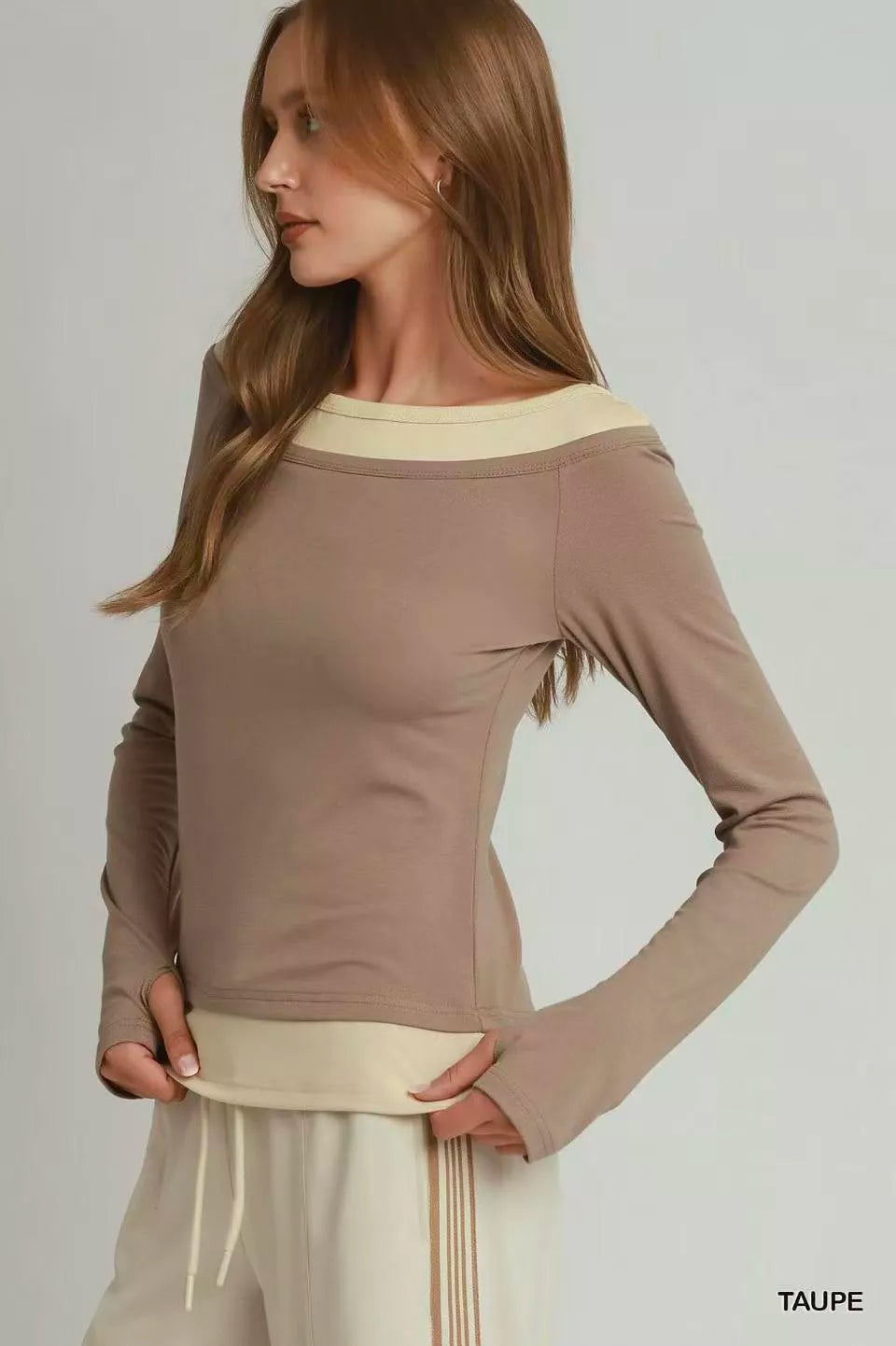 Layered long sleeve top with taupe body and cream underlayer hem showing at waist
