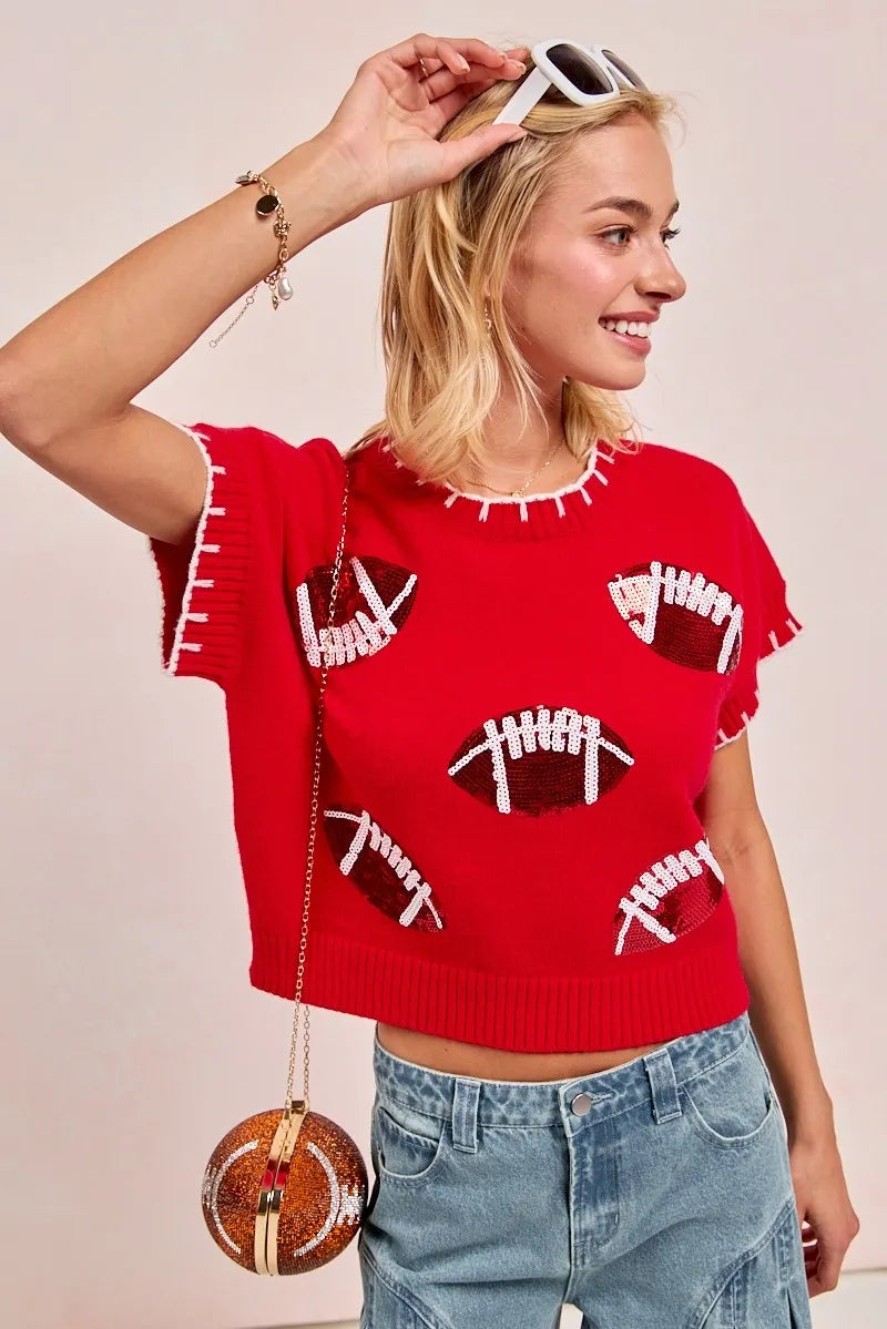 Women's red football knit top with white football patches and crew neckline