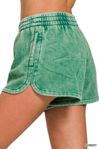 Acid-washed dolphin shorts in forest green, side view