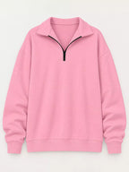 Pink oversized zip-neck sweatshirt with black half-zip and ribbed collar cuffs
