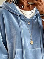 Light blue velvet hoodie close-up with hood ties and front pouch pocket.