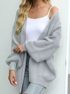 Chunky knit open cardigan with lantern sleeves, light gray color.