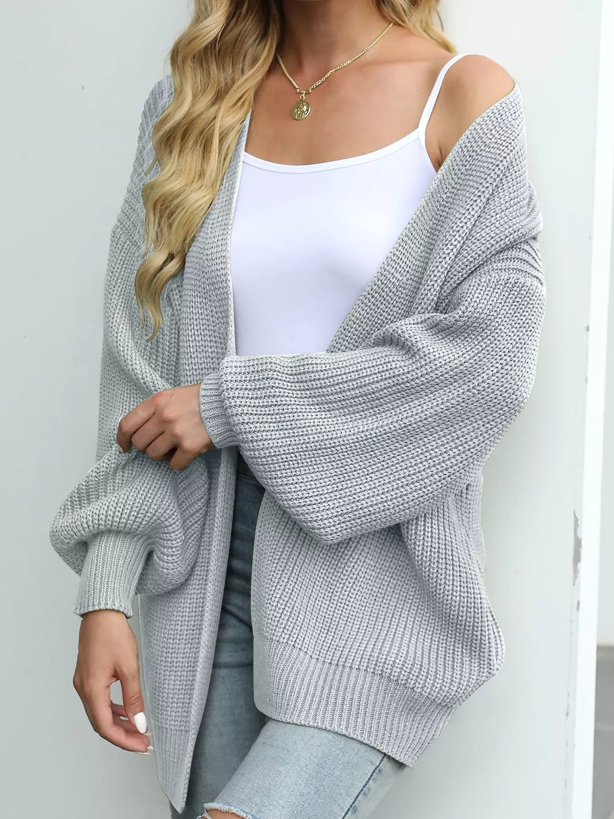 Chunky knit open cardigan with lantern sleeves, light gray color.