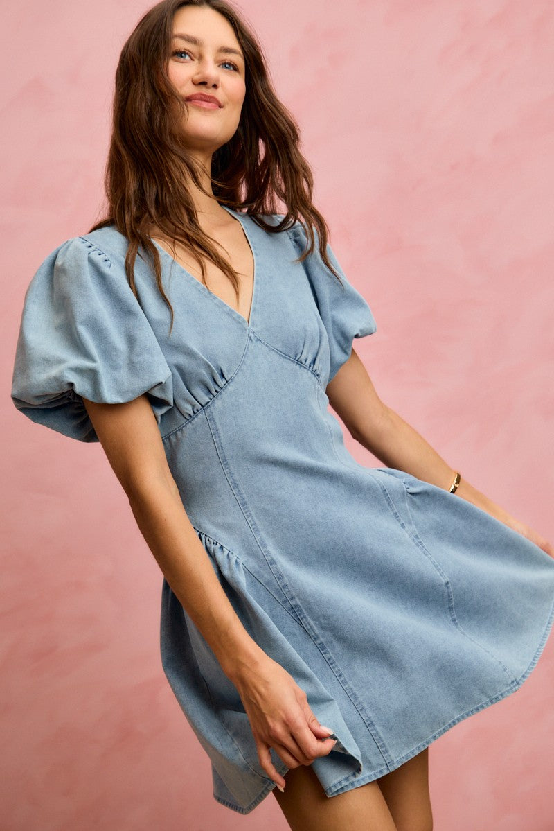 Light denim V-neck mini dress with bubble sleeves and flared skirt, front close-up