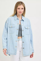 Light blue denim shacket with two flap chest pockets, button placket, and curved hem
