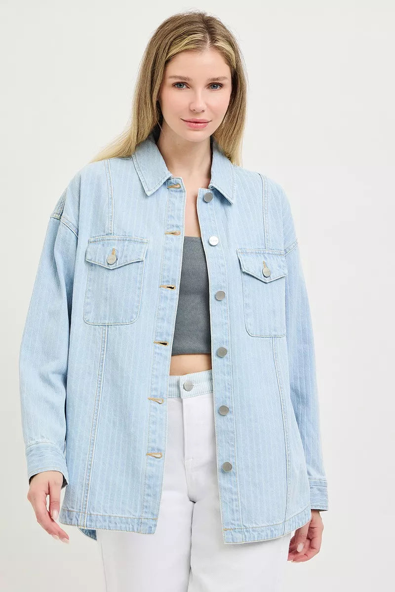 Light blue denim shacket with two flap chest pockets, button placket, and curved hem