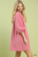 Rose pink textured mini dress with V-neck and wide puff sleeves, scalloped hem