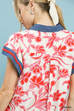 Close-up back of floral flutter top with pink-and-white print and navy trim