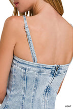 Back of light wash denim dress with spaghetti straps and stitched panel seams