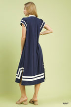 Back view of navy linen-cotton midi dress with white geometric hem and short sleeves