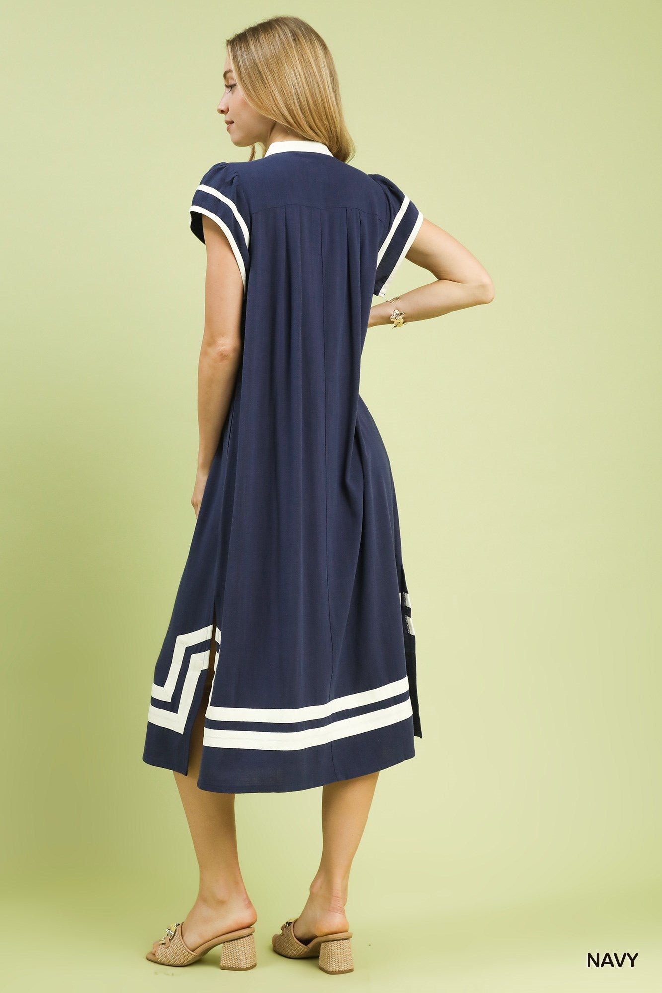 Back view of navy linen-cotton midi dress with white geometric hem and short sleeves