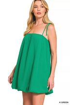 Green mini dress with spaghetti straps and gathered bust, flowy skirt