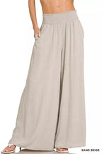 Sand beige wide-leg lounge pants with smocked waistband and flowing drape
