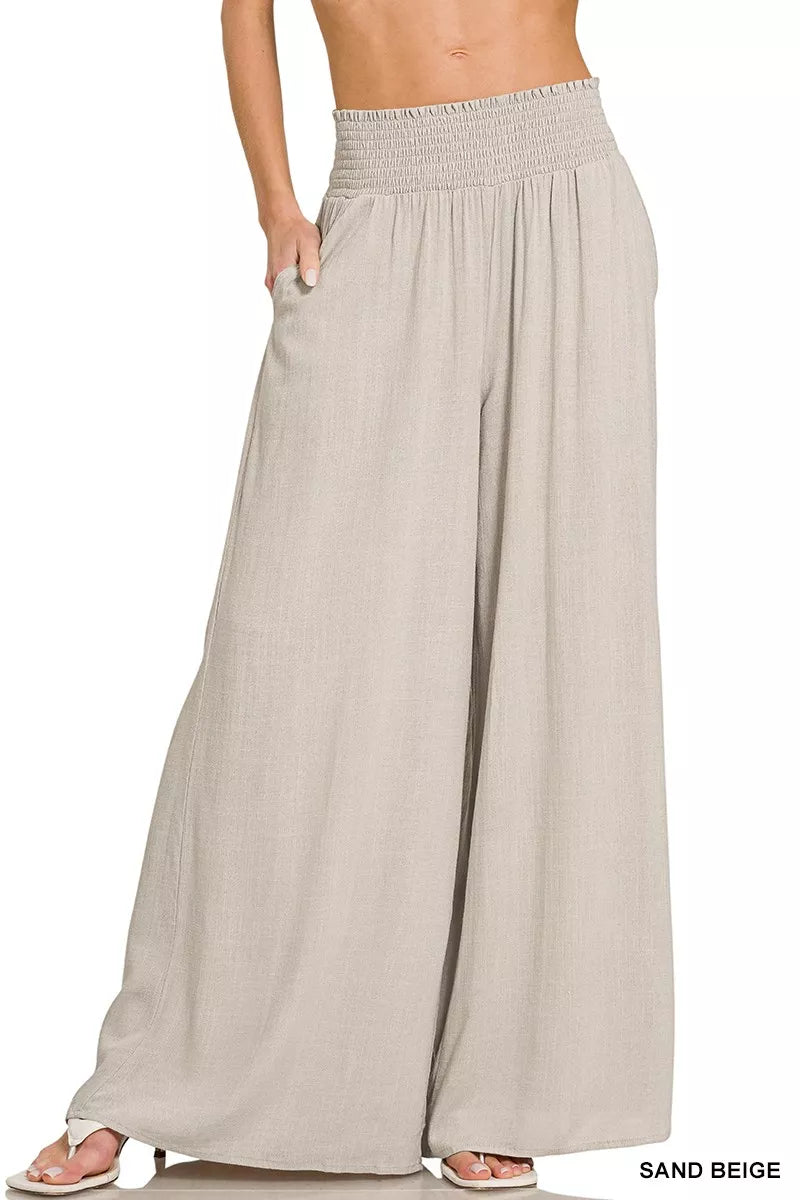 Sand beige wide-leg lounge pants with smocked waistband and flowing drape