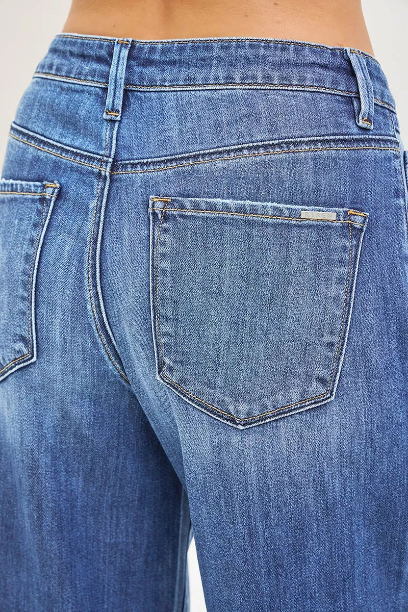 Women's medium-wash denim jeans back closeup, rear yoke and pocket detail
