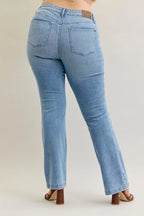 Light blue mid-rise bootcut jeans back view with patch pockets and straight bootcut leg