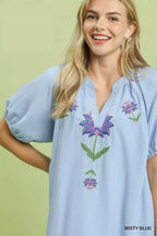 Light blue babydoll dress front with embroidered floral V-neck detail