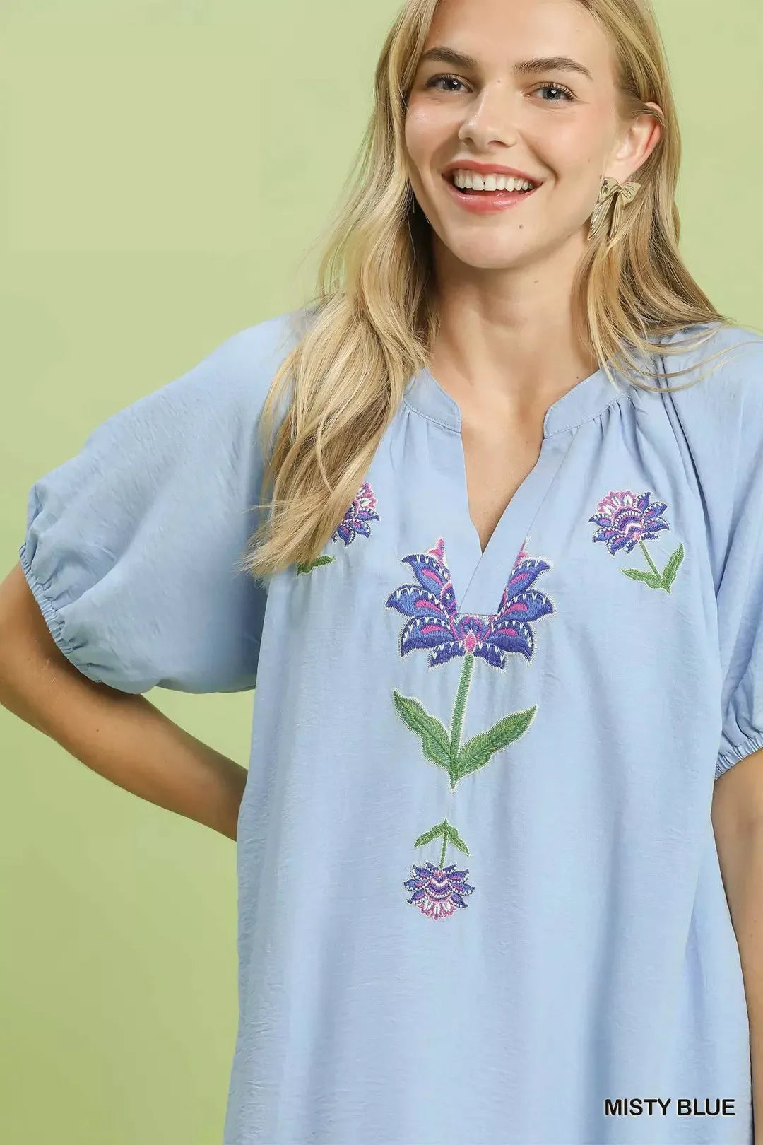 Light blue babydoll dress front with embroidered floral V-neck detail