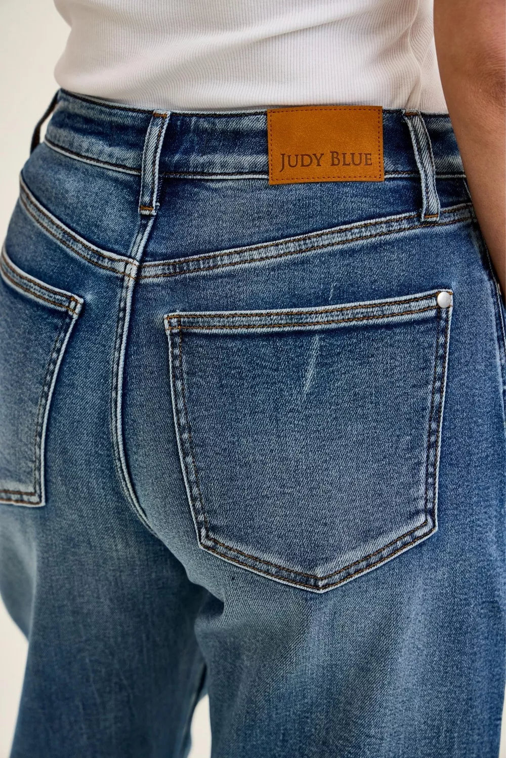 Petite indigo wash jeans close-up with brand patch label and front pocket