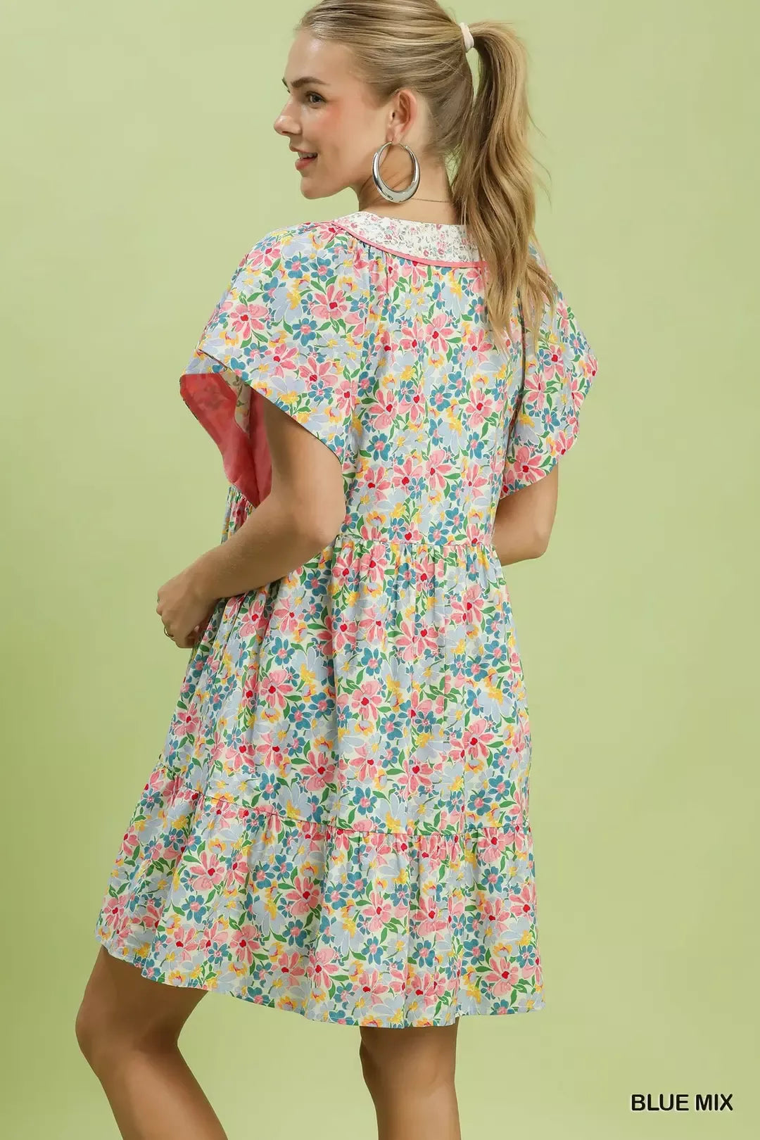 Back view of floral blue mix mini dress with tiered ruffle hem and flutter sleeves