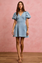 Light wash denim mini dress with V-neck and puff bubble sleeves, fit-and-flare skirt