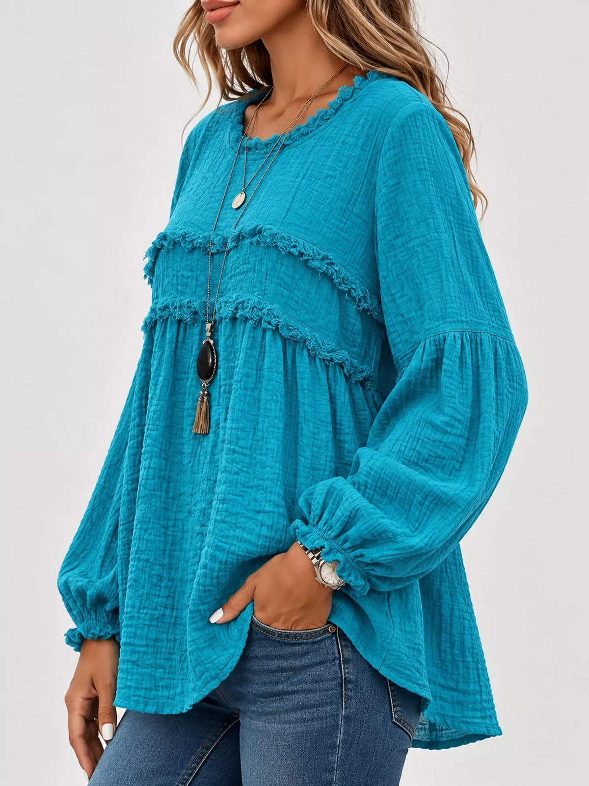 Teal peplum blouse with frayed yoke detail and long balloon sleeves