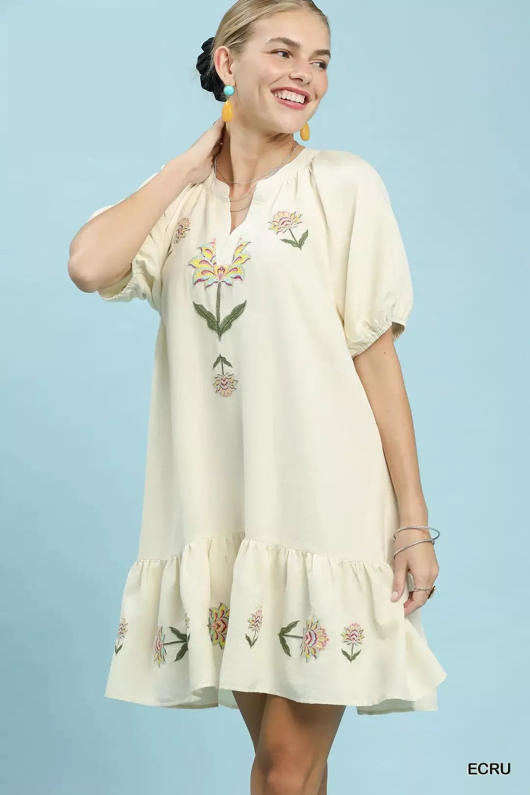 Ecru embroidered floral babydoll dress with V-neck, short puff sleeves, tiered hem