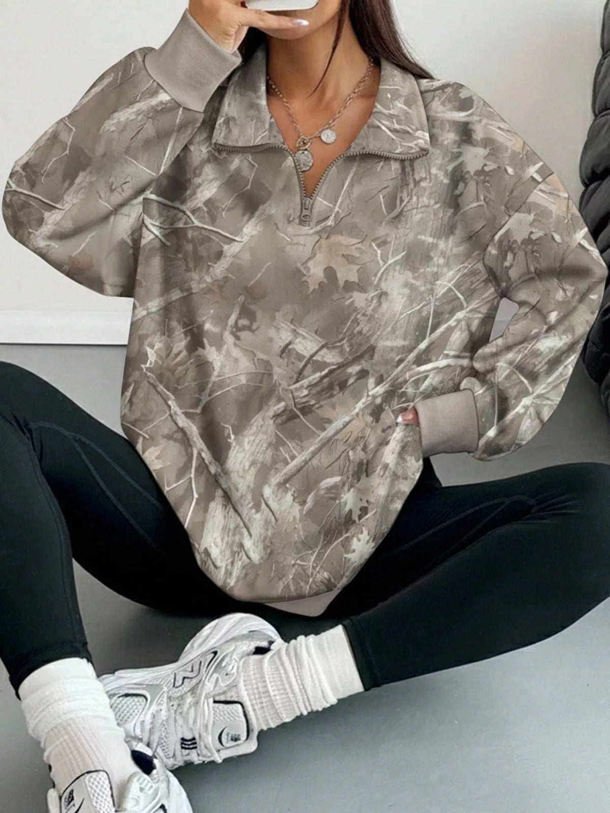Light gray camo zip-neck oversized sweatshirt, half-zip neck and long sleeves