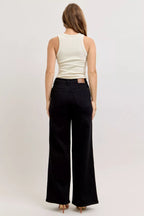 High-waisted wide-leg black denim jeans, back view with yoke and belt loops