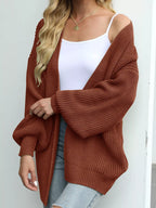 Chunky knit lantern sleeve cardigan in rust brown, open front, chunky textured knit.
