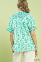 Turquoise geometric printed smocked top with short puff sleeves and back yoke detail