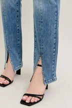 Blue denim jeans hem with front leg slit and straight pant leg opening