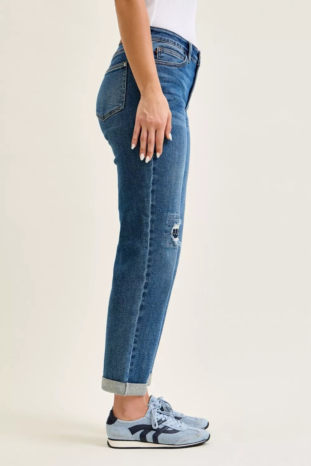 Women’s mid-rise boyfriend jeans with straight leg and small side distressed repair