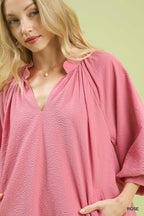 Rose pink textured V-neck mini dress with gathered neckline detail and balloon sleeve cuff