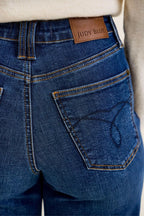 Dark indigo jeans close-up: stitched pocket and 'JUDY BLUE' patch