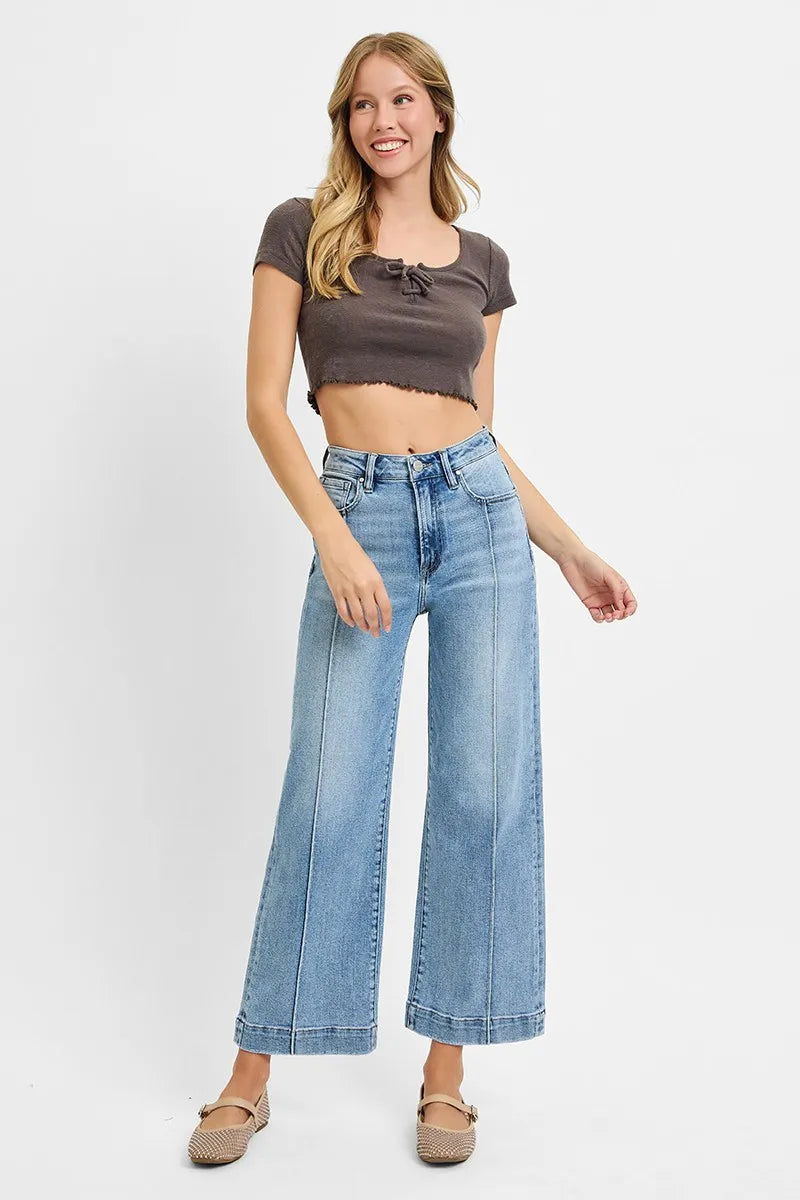 Light blue high-rise wide-leg crop jeans on model with ankle-length wide hems