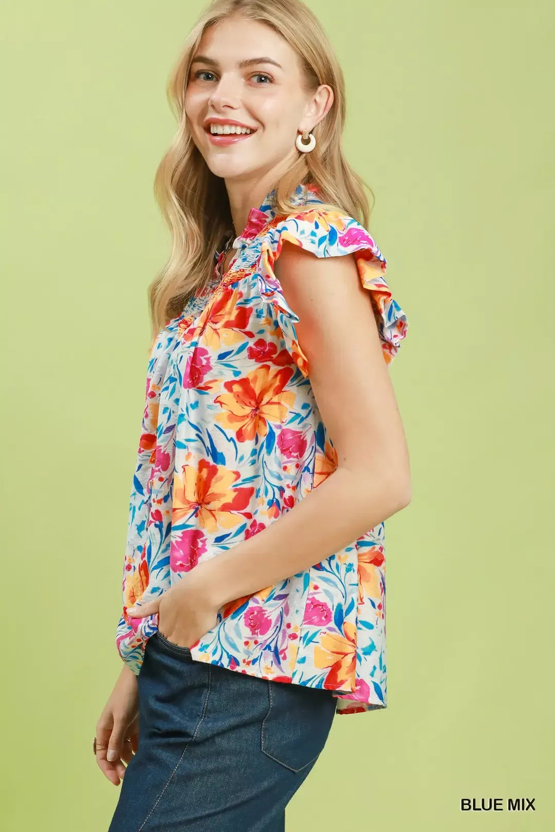 Floral blouse with smocked yoke and ruffle sleeves, blue base with bright multicolor blooms