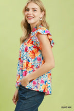 Floral blouse with smocked yoke and ruffle sleeves, blue base with bright multicolor blooms