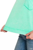 Mint acid-washed oversized pocket tee with curved hem and visible pocket stitching