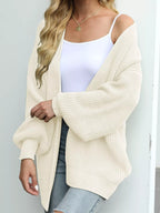 Chunky knit cardigan with lantern sleeves and open front, cream color.